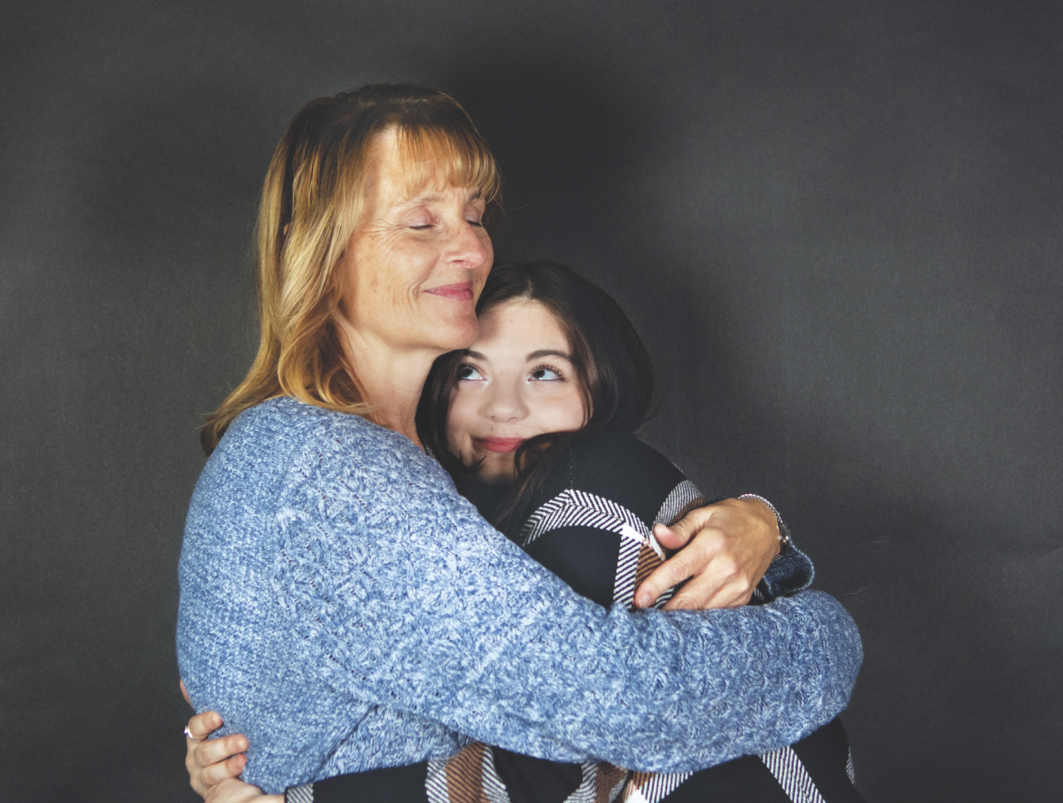 Senior Kristina Keys hugs her mom Dec. 4 in Room 151.